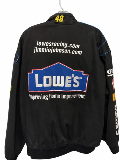 The back of the black racing jacket on a hanger, with a large Lowe's logo across the shoulders, a yellow number 48 at the collar and sponsor lettering down both sleeves.