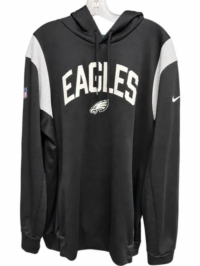 The front of the black Nike Eagles hoodie on a hanger, with white EAGLES lettering, the team logo, white ribbed shoulder panels and an NFL shield at the chest.