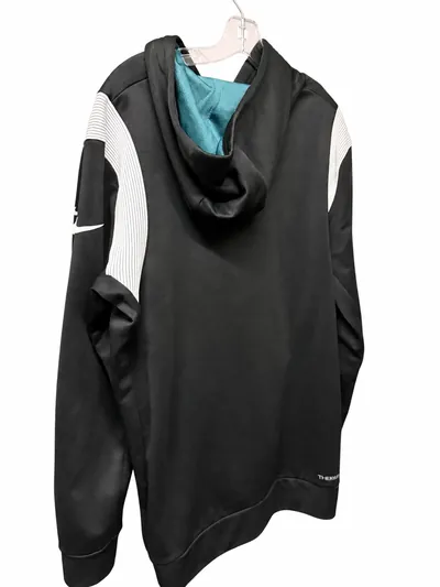 The hoodie from behind and slightly to one side, showing the teal hood lining and the Swoosh on the sleeve.