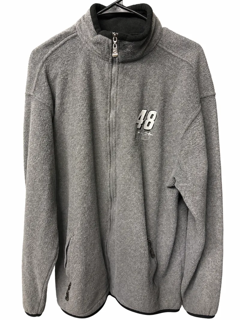 The gray full-zip fleece on a hanger, with an embroidered number 48 and a signature detail on the chest and a black-lined stand collar.